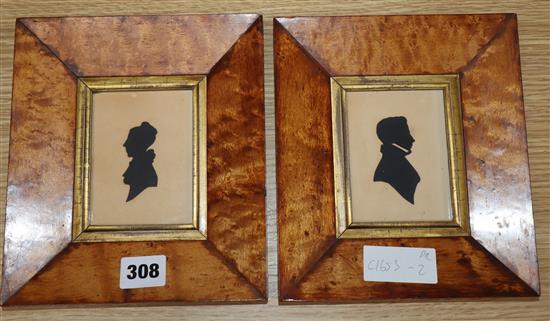 A pair of early 19th century cut paper silhouettes of Captain T.R. Shervinton and his wife, maple framed